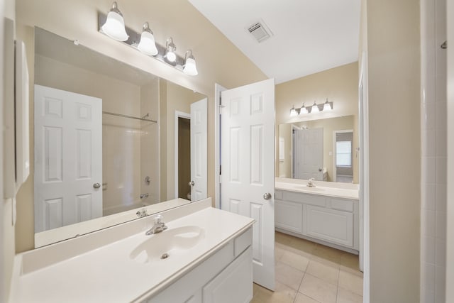 bathroom with tile patterned floors, vanity, and shower / tub combination