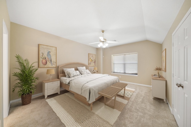 carpeted bedroom with vaulted ceiling and ceiling fan