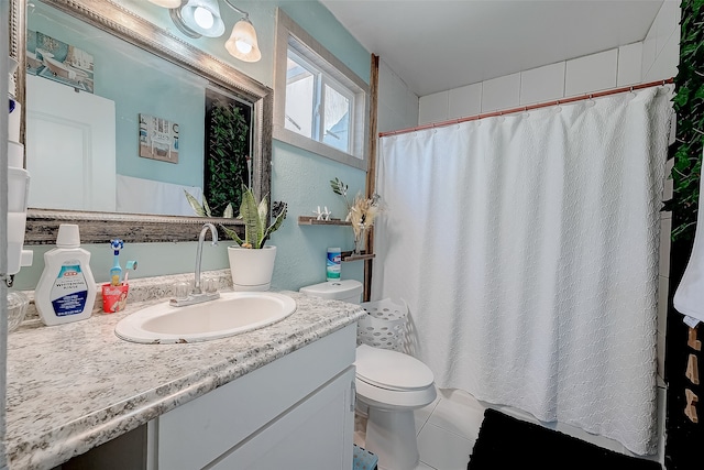 bathroom with tile patterned flooring, vanity, toilet, and a shower with curtain