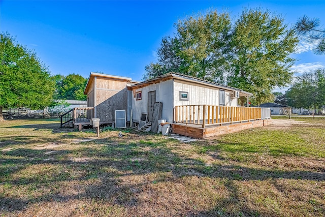 rear view of property featuring a yard