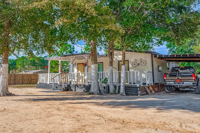 view of front of home featuring a porch and a carport