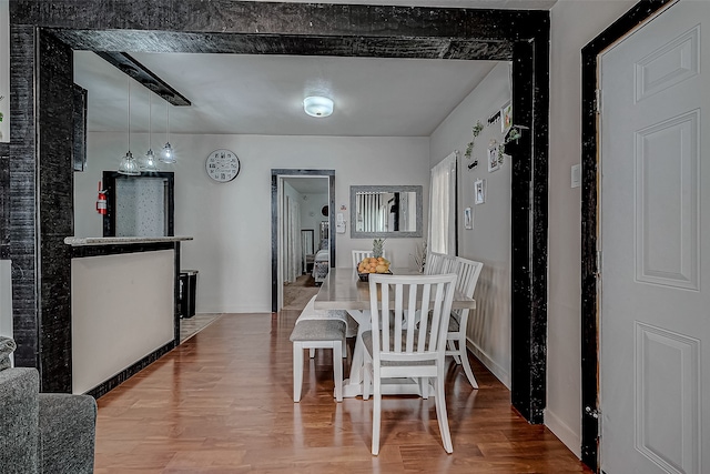 dining space featuring wood-type flooring