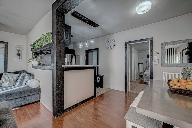 kitchen featuring pendant lighting and hardwood / wood-style flooring