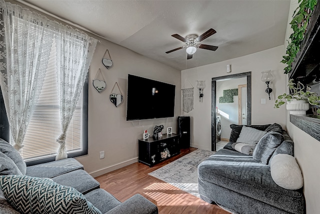 living room featuring ceiling fan, a healthy amount of sunlight, and light hardwood / wood-style floors