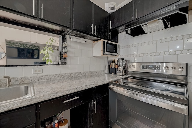 kitchen with decorative backsplash, sink, and stainless steel appliances