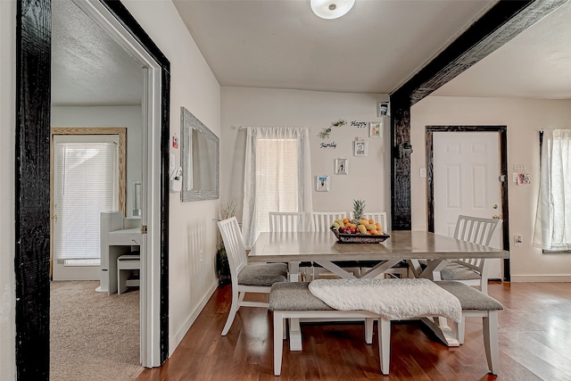 dining space with hardwood / wood-style flooring