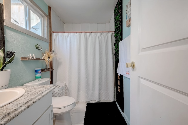 bathroom featuring a shower with curtain, tile patterned flooring, vanity, and toilet