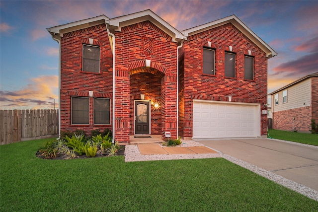 front of property featuring a lawn and a garage