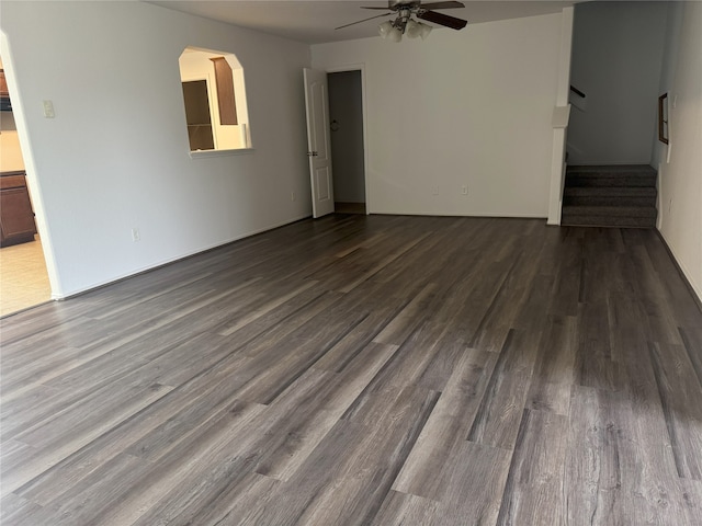 empty room with dark hardwood / wood-style floors and ceiling fan