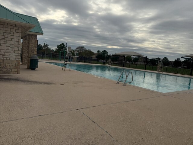 view of swimming pool featuring grilling area