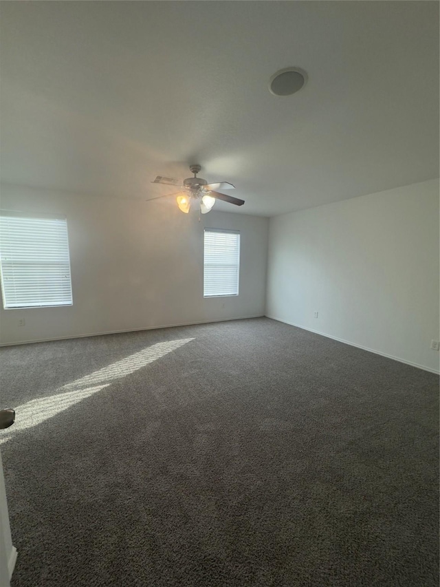 carpeted spare room with ceiling fan