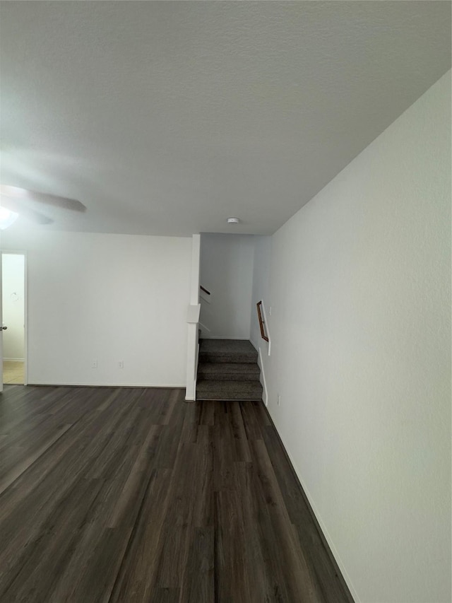 spare room with a textured ceiling and dark wood-type flooring