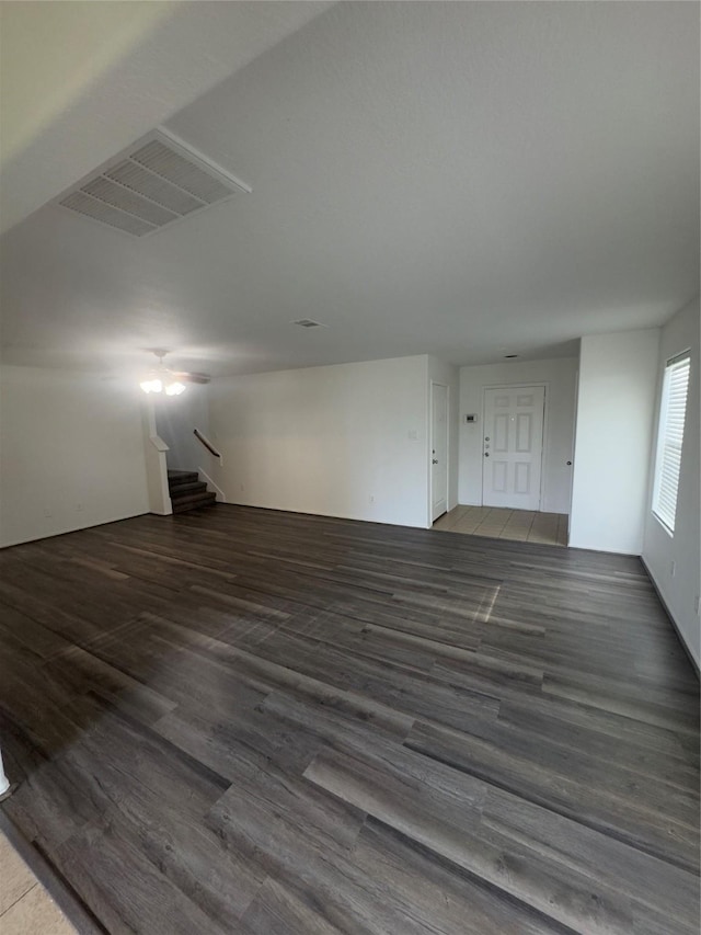 unfurnished living room with dark hardwood / wood-style flooring