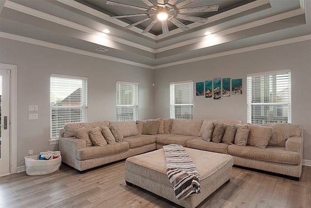 living room with plenty of natural light, ceiling fan, light wood-type flooring, and crown molding