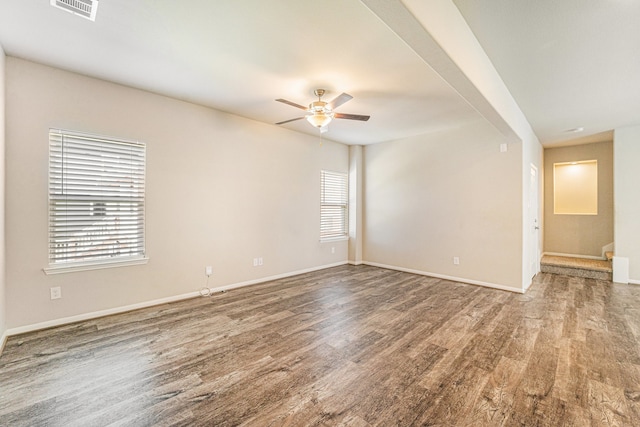 empty room featuring hardwood / wood-style floors, plenty of natural light, and ceiling fan