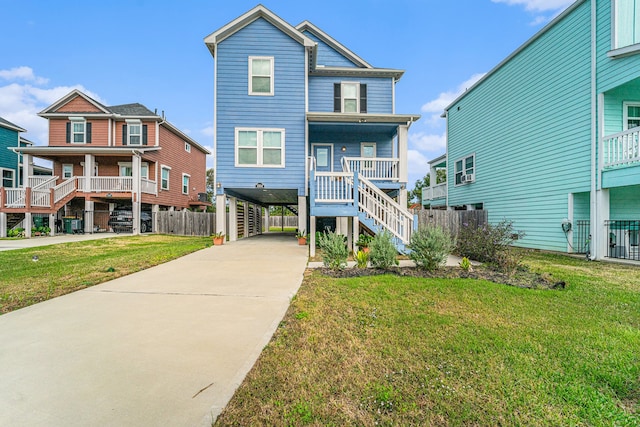 view of front of home featuring a front yard, a porch, and a carport