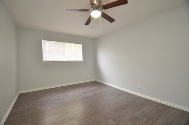 unfurnished room with ceiling fan and dark wood-type flooring