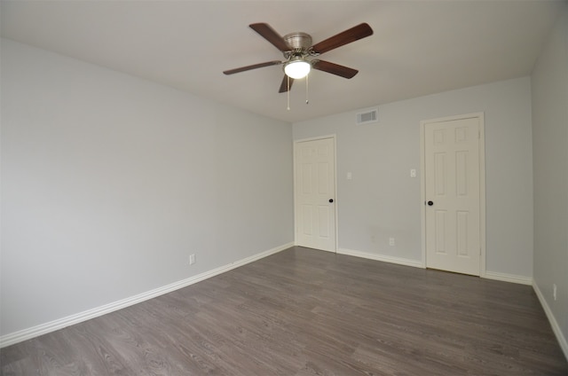 unfurnished room with dark hardwood / wood-style flooring and ceiling fan