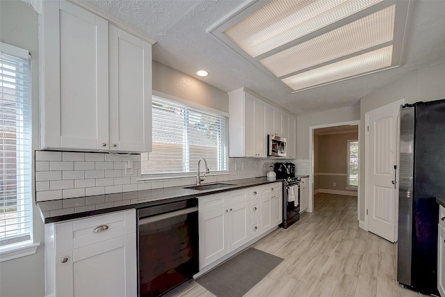 kitchen featuring sink, white cabinets, and stainless steel appliances