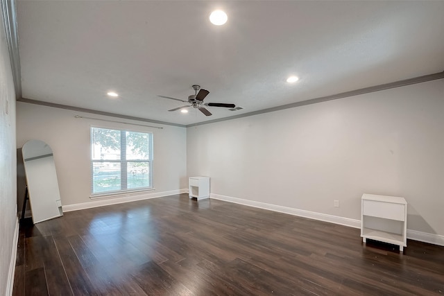 spare room with dark hardwood / wood-style floors, ceiling fan, and ornamental molding