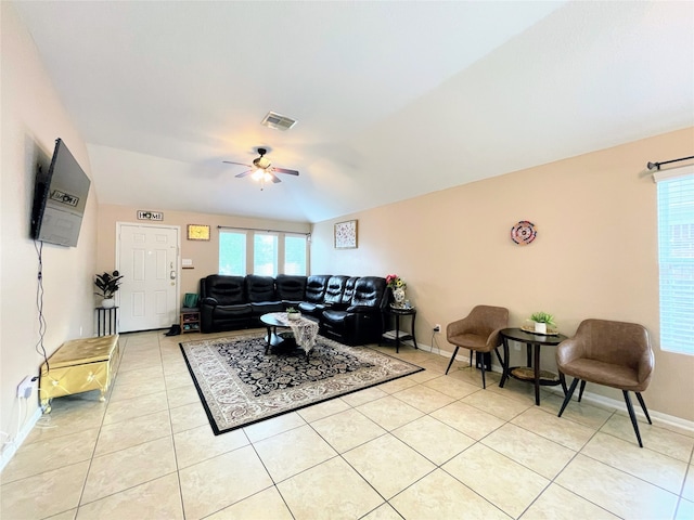 living room featuring vaulted ceiling, ceiling fan, and light tile patterned flooring