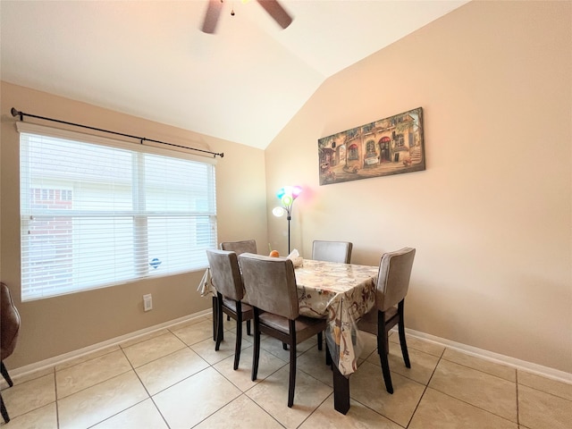 tiled dining room with ceiling fan and lofted ceiling