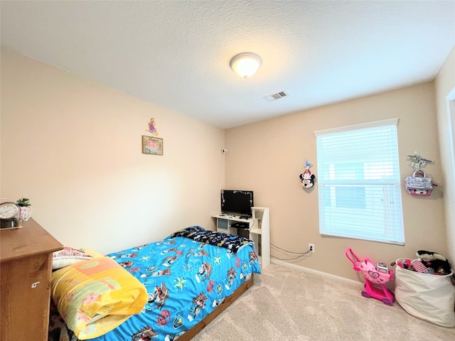 bedroom featuring carpet and a textured ceiling