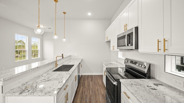 kitchen featuring sink, hanging light fixtures, light stone countertops, white cabinetry, and stainless steel appliances