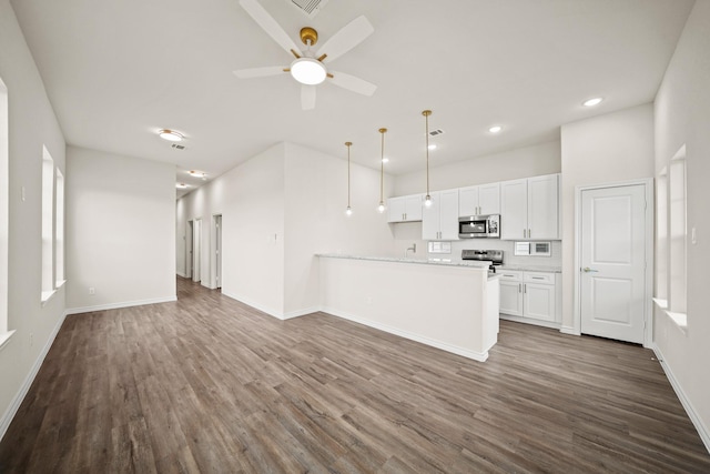 unfurnished living room with ceiling fan and dark wood-type flooring