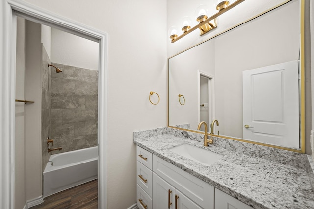 203 3rd St, Rosenberg, TX 77471 - full bathroom with wood finished floors, vanity, tub / shower combination, and baseboards