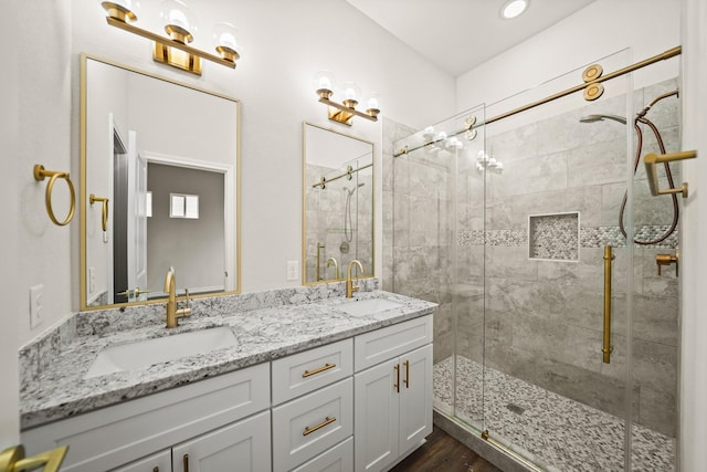 bathroom featuring hardwood / wood-style floors, vanity, and an enclosed shower