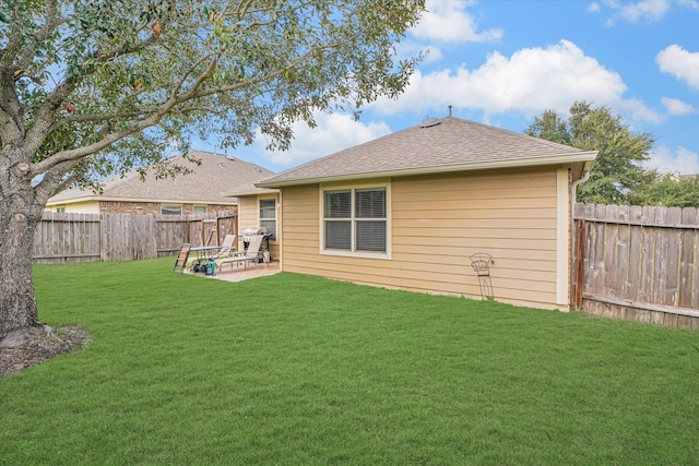 rear view of house featuring a yard and a patio area