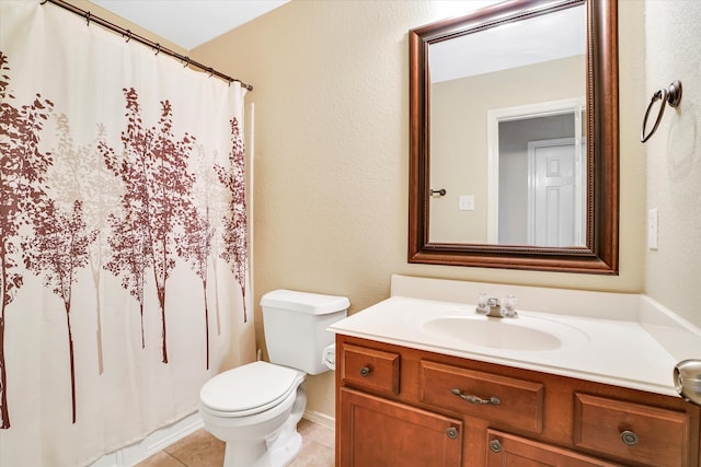 bathroom with tile patterned floors, vanity, and toilet