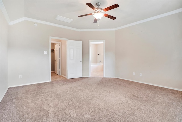 empty room featuring lofted ceiling, light colored carpet, ceiling fan, and crown molding