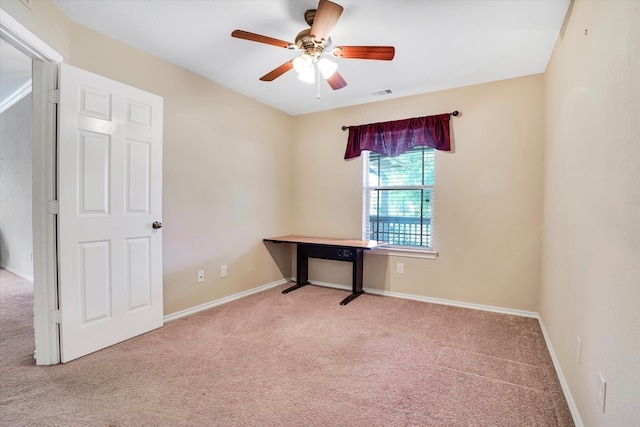 spare room featuring light colored carpet and ceiling fan