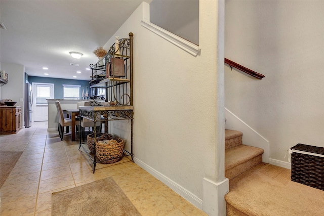 stairway with tile patterned flooring