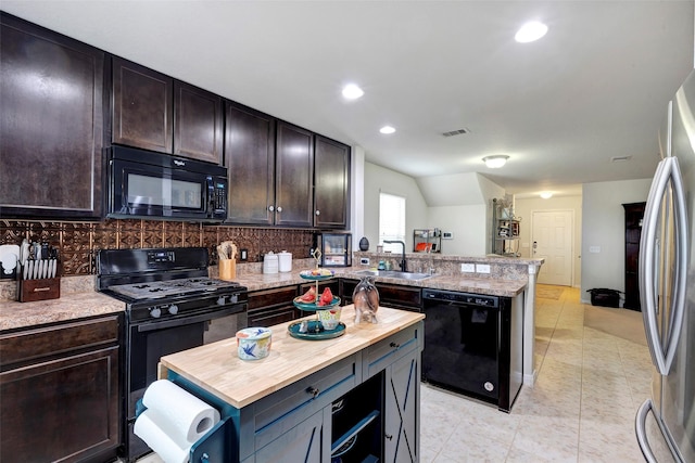 kitchen with black appliances, sink, tasteful backsplash, a kitchen island, and dark brown cabinetry