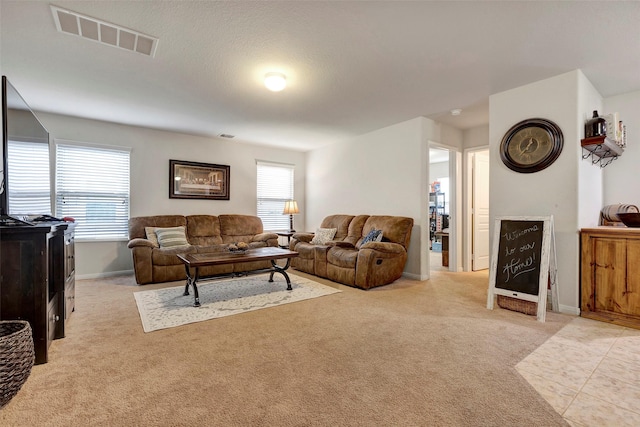 living room with light colored carpet and a textured ceiling