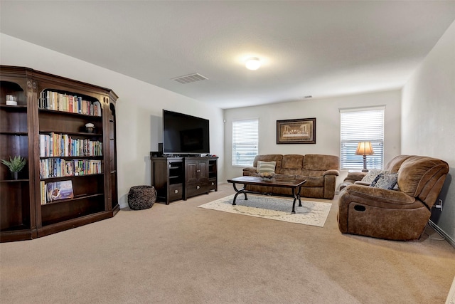 carpeted living room featuring a healthy amount of sunlight