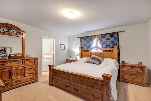 carpeted bedroom featuring a textured ceiling