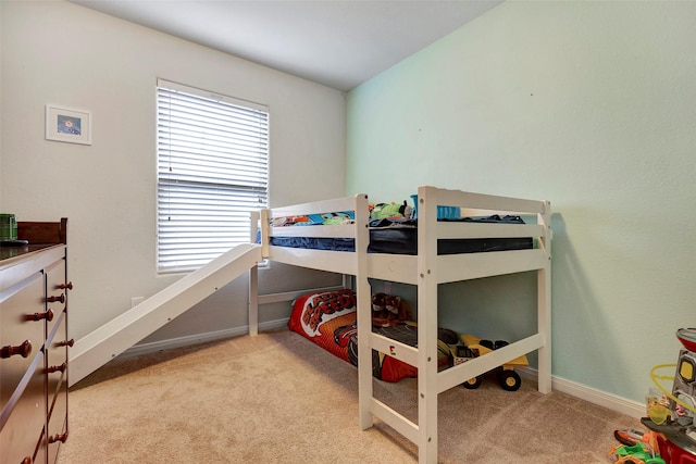 bedroom featuring light carpet