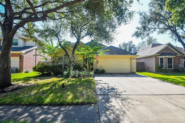 view of front of home featuring a garage and a front lawn