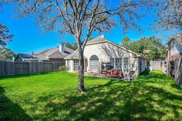 rear view of house with a yard