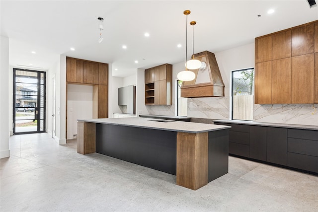 kitchen with tasteful backsplash, stainless steel fridge, a center island, and decorative light fixtures