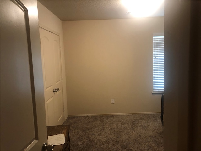 carpeted spare room with a textured ceiling