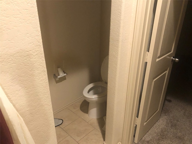 bathroom with tile patterned floors and toilet