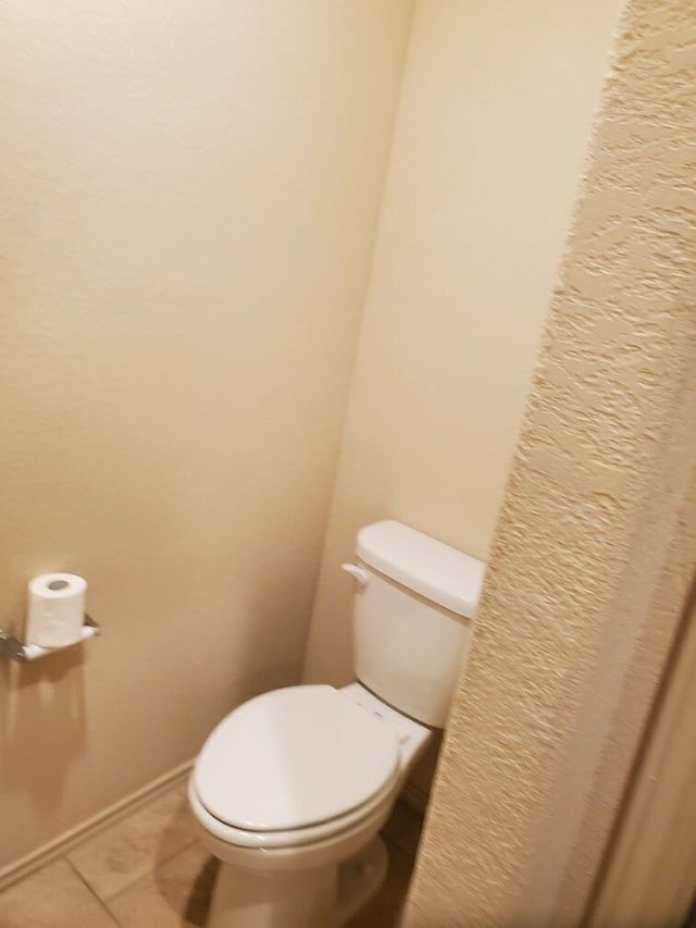 bathroom featuring tile patterned flooring and toilet