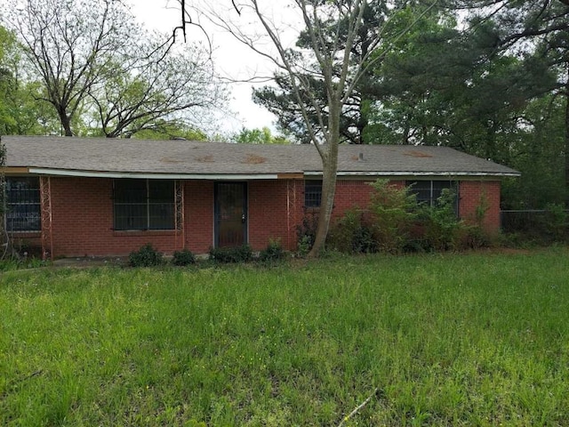 ranch-style home with a front lawn