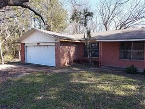 view of front of home with a garage and a front lawn