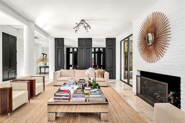 living room featuring crown molding and a brick fireplace